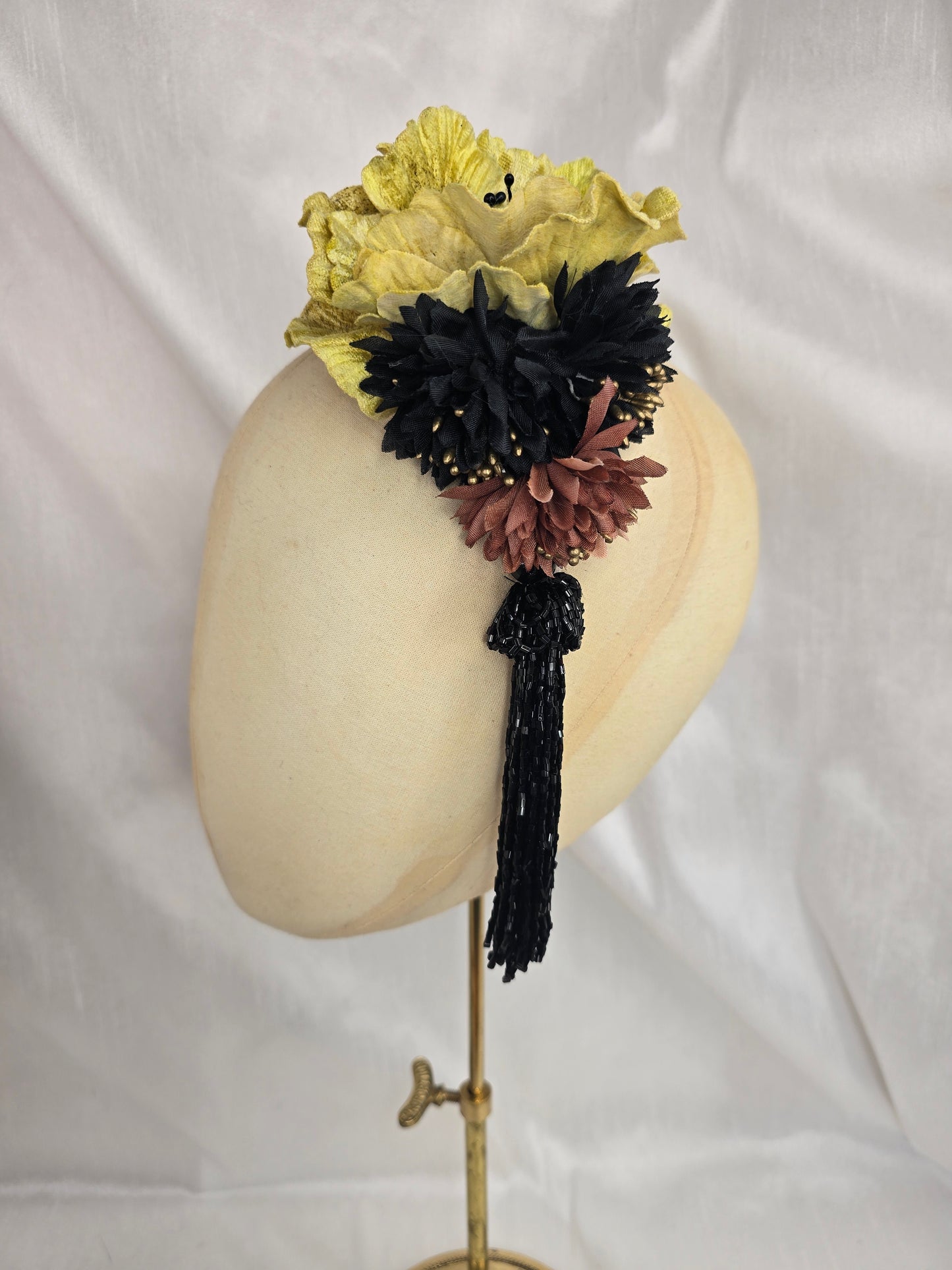 Medium chartruese yellow, black and gold flower headpiece with black beaded tassel
