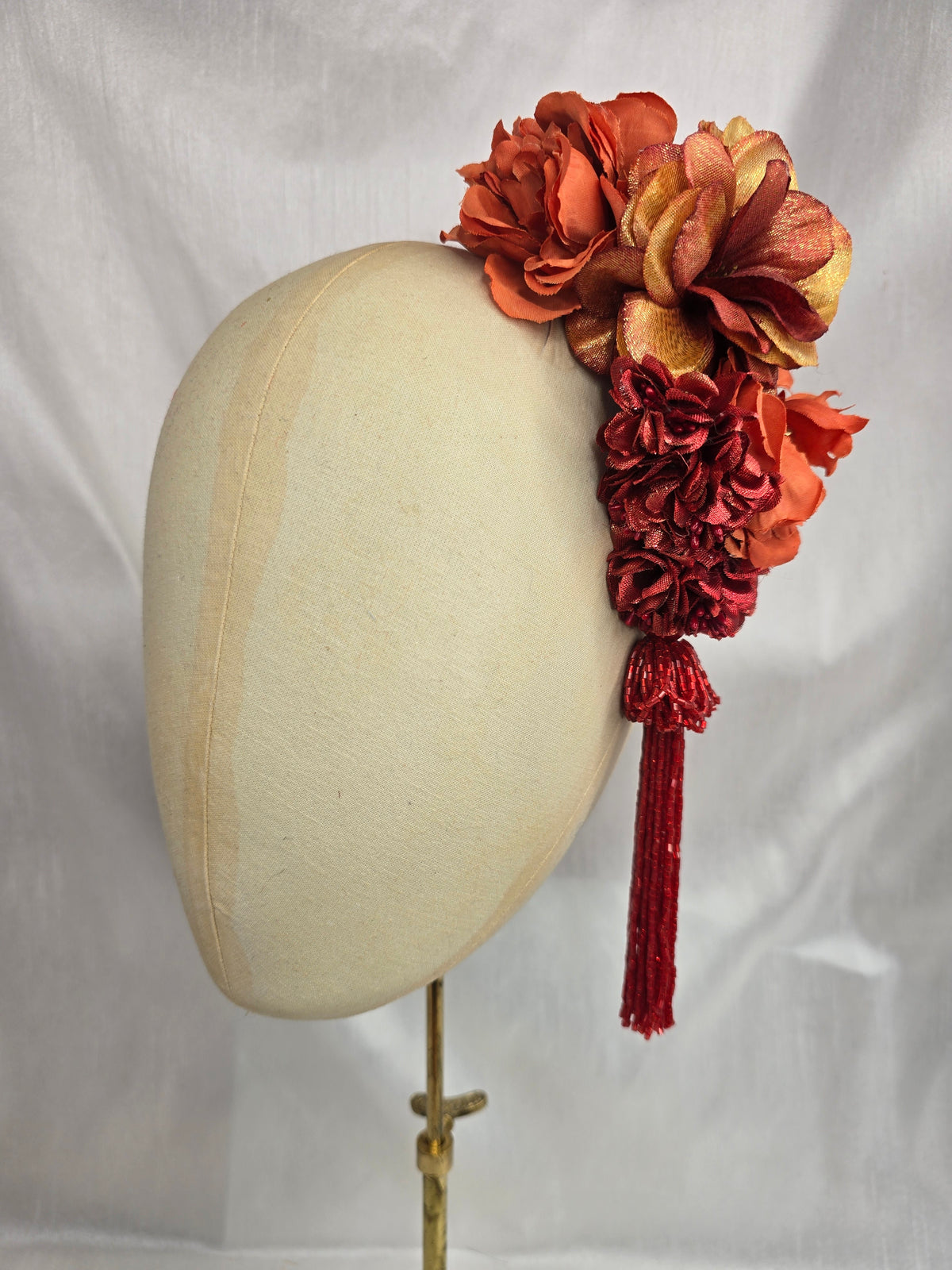Medium autumn orange flower headpiece/corsage with beaded tassel