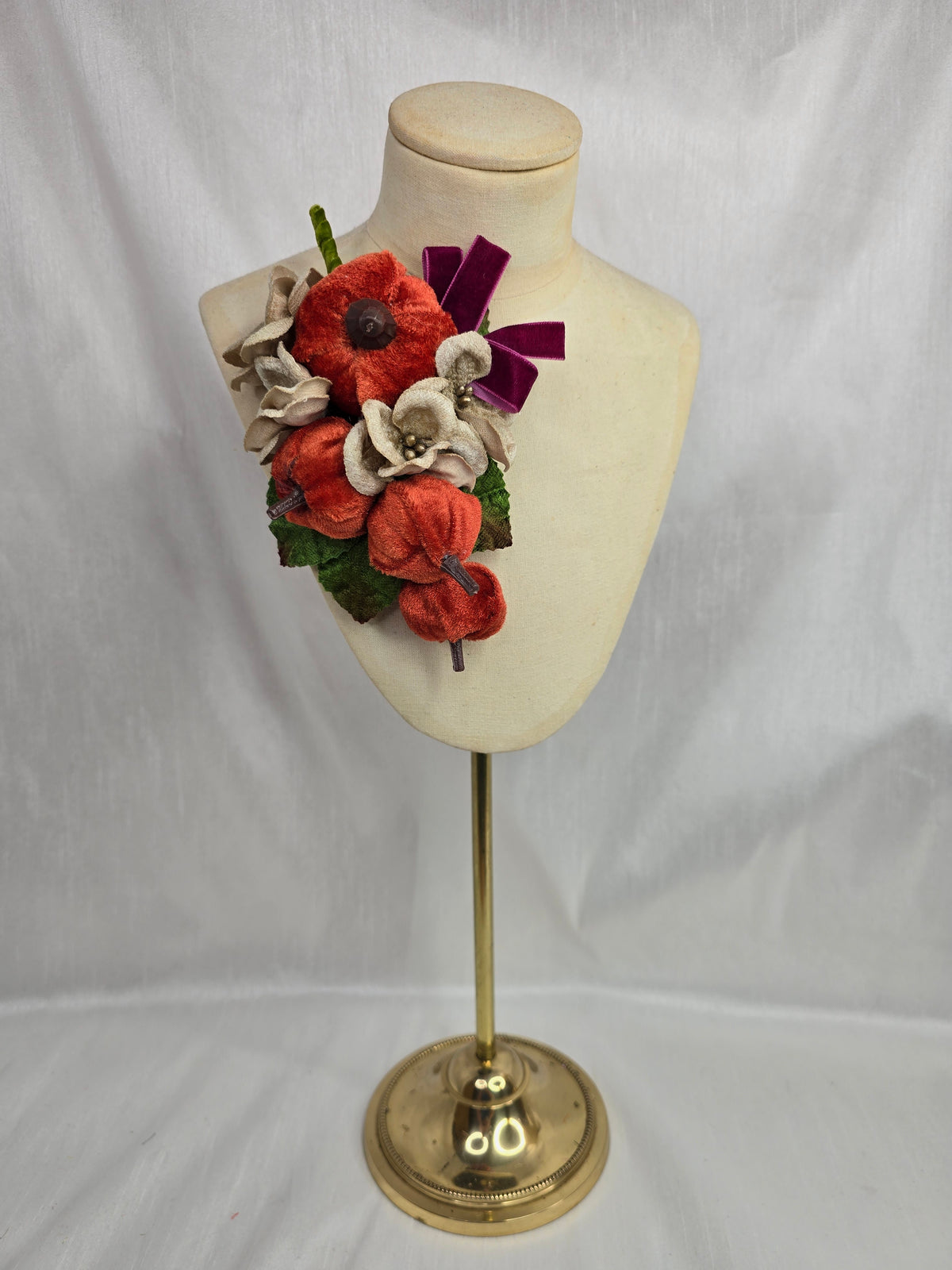 Velvet pumpkin corsage with maroon bow