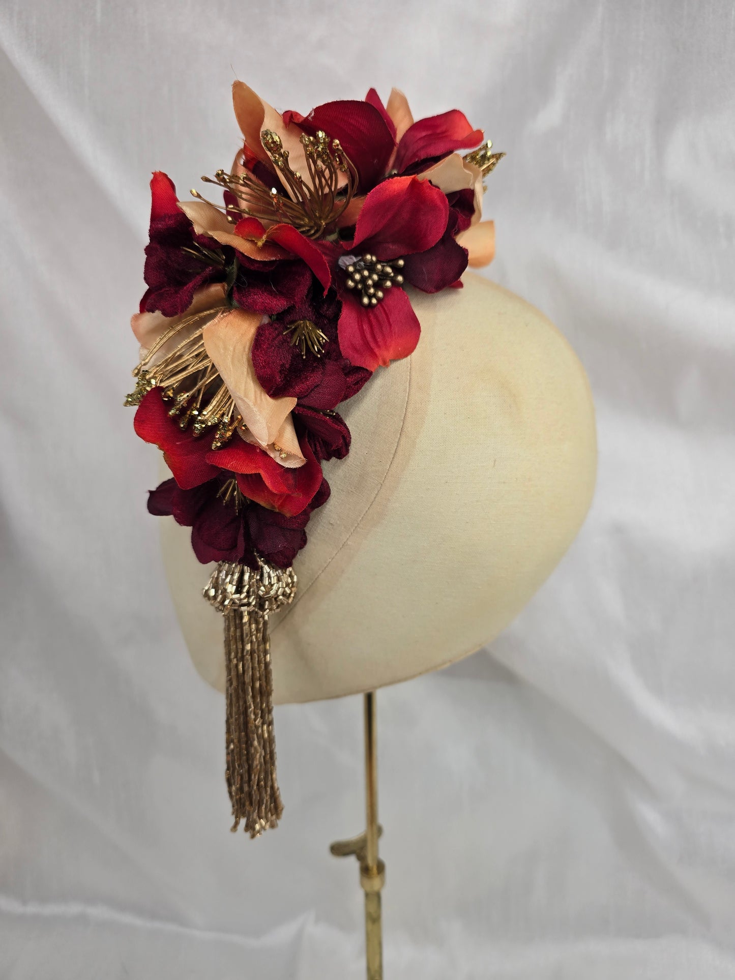 Large pale orange, red and gold flower headpiece with gold beaded tassel