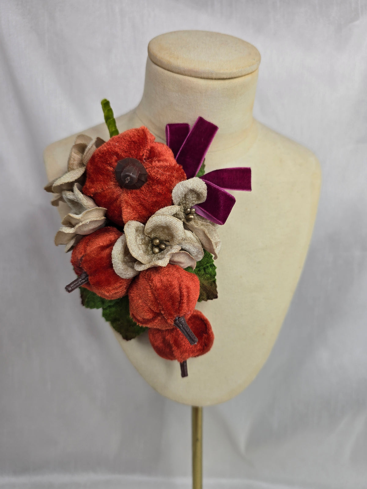 Velvet pumpkin corsage with maroon bow