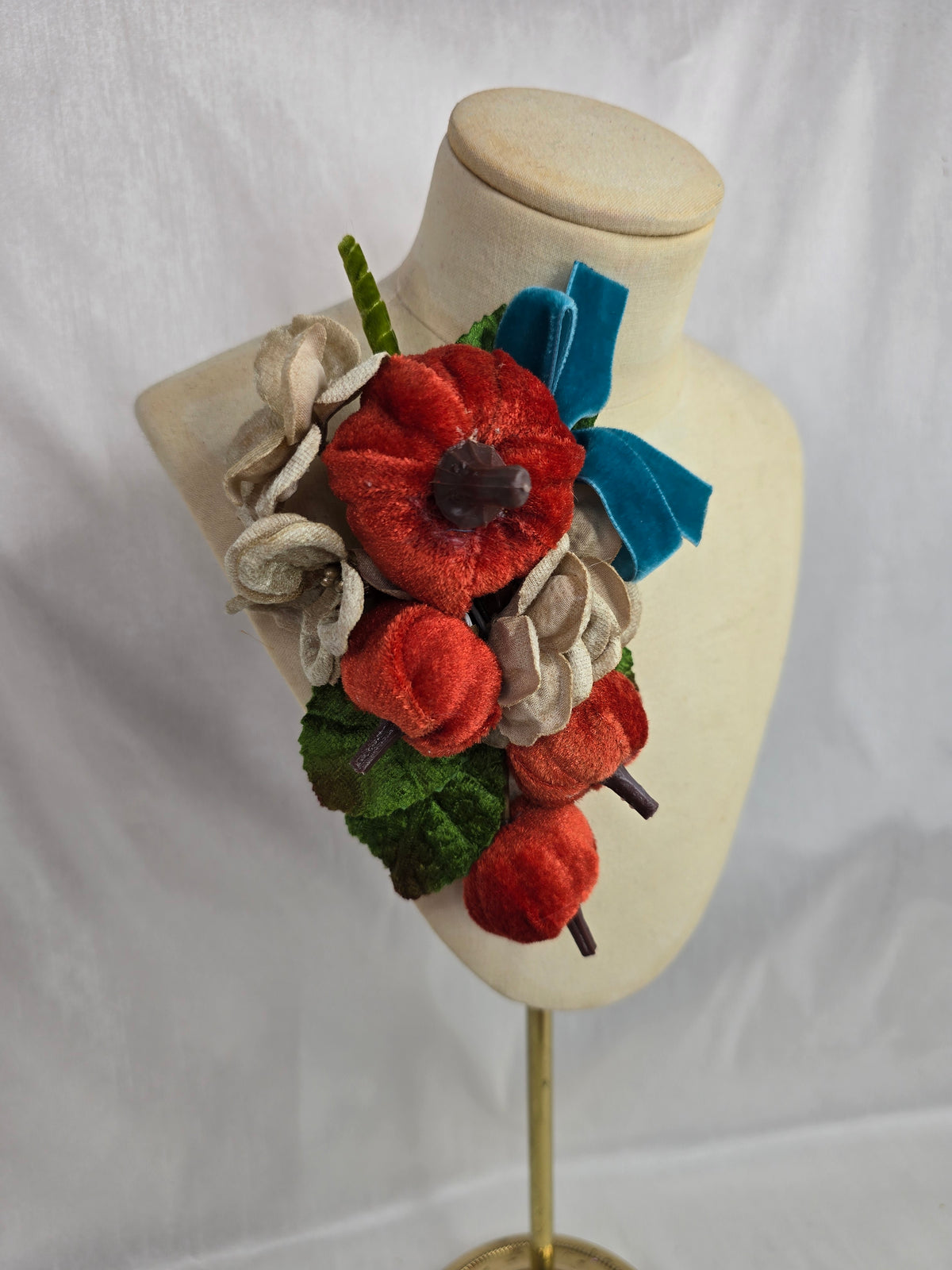 Velvet pumpkin corsage with teal bow