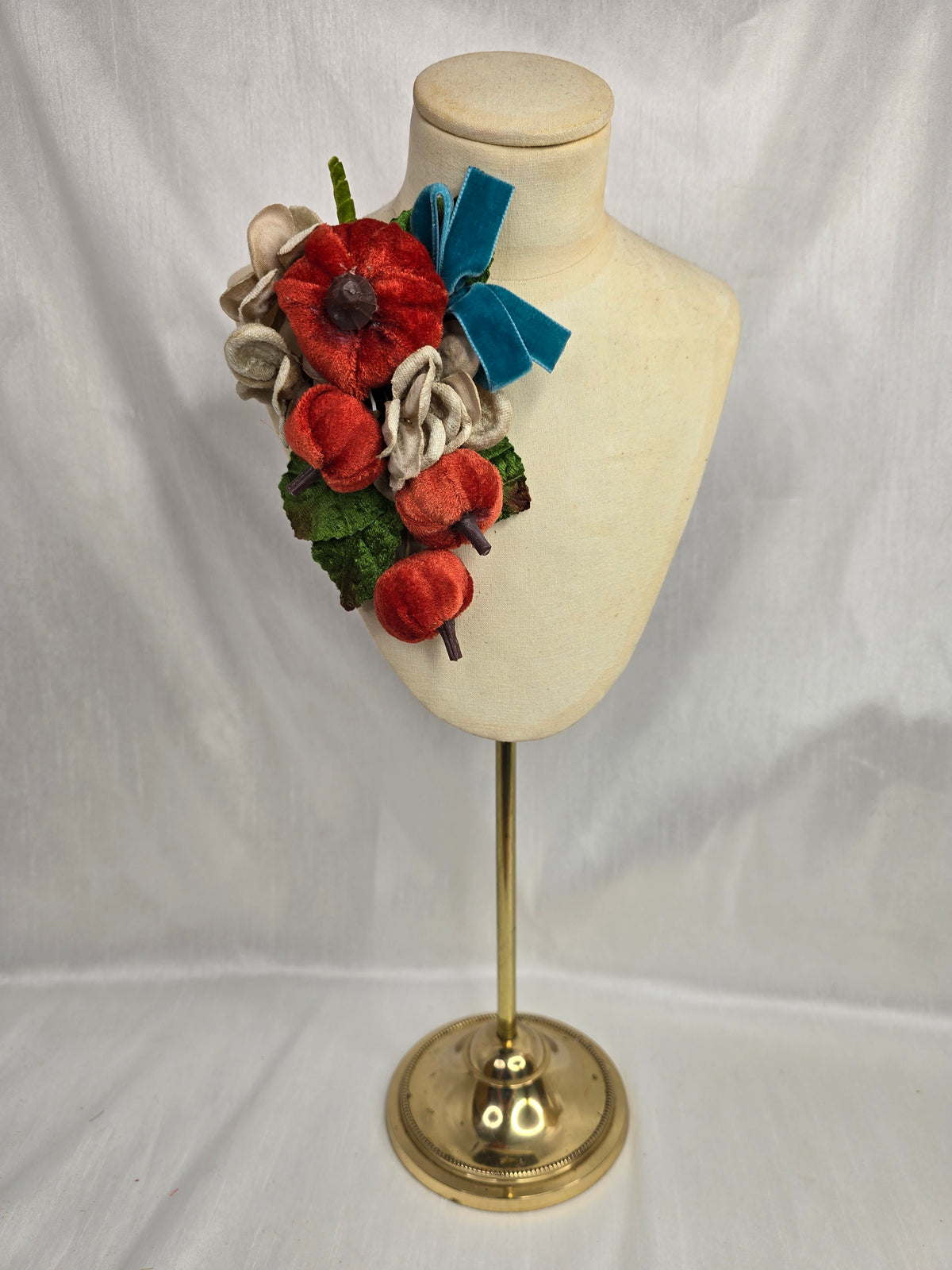 Velvet pumpkin corsage with teal bow