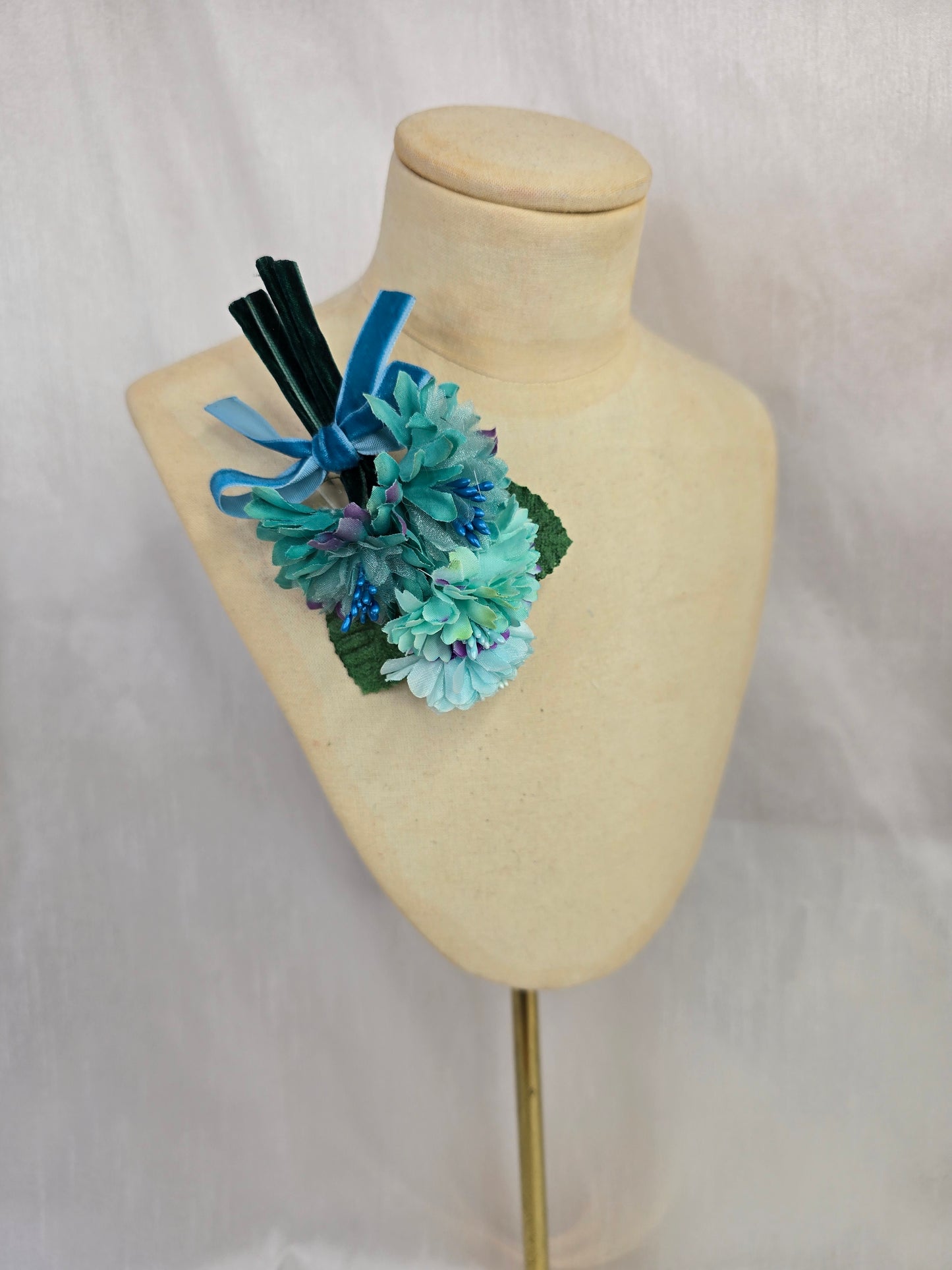 Small aqua blossom corsage