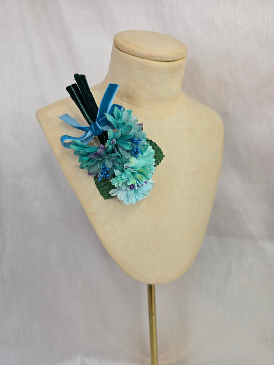 Small aqua blossom corsage