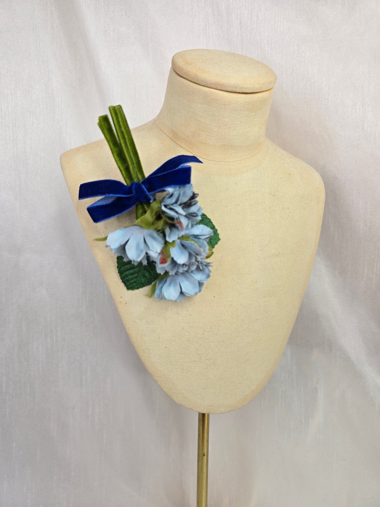 Small blue grey blossom corsage