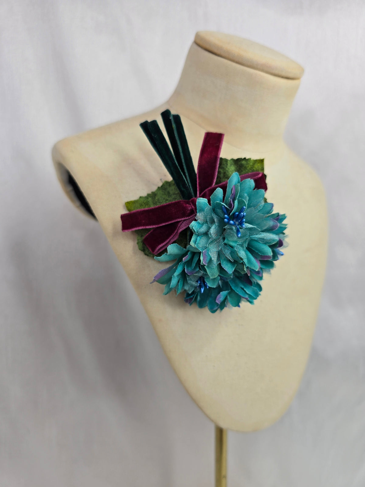 Small teal blossom corsage